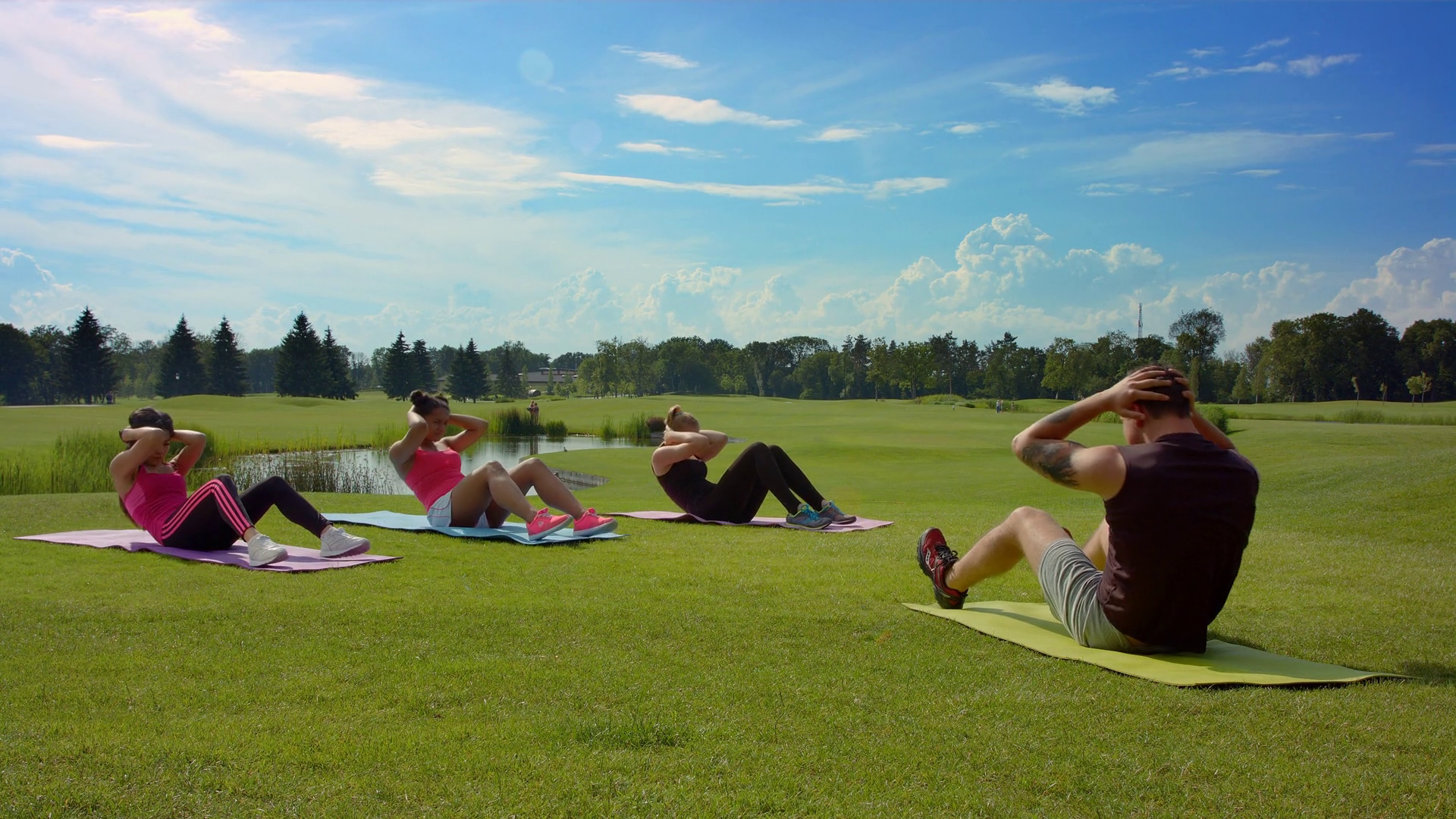 Outdoor fitness group doing sit up exercise. People group ...